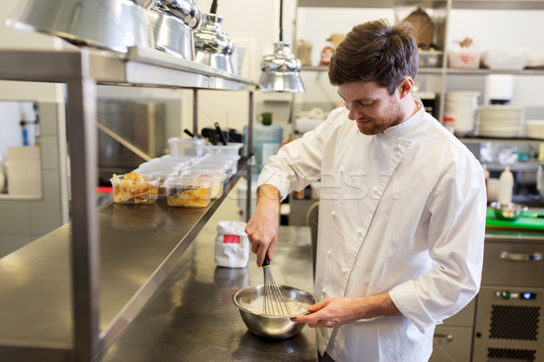 happy male chef cooking food at restaurant kitchen Stock photo © dolgachov