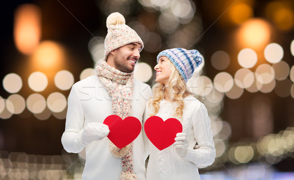 couple with red hearts over christmas lights Stock photo © dolgachov