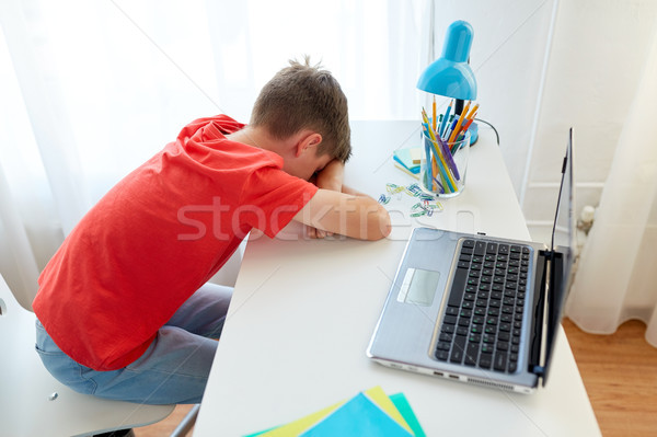 tired or sad student boy with laptop at home Stock photo © dolgachov