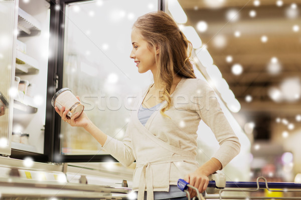 woman with ice cream at grocery store freezer Stock photo © dolgachov