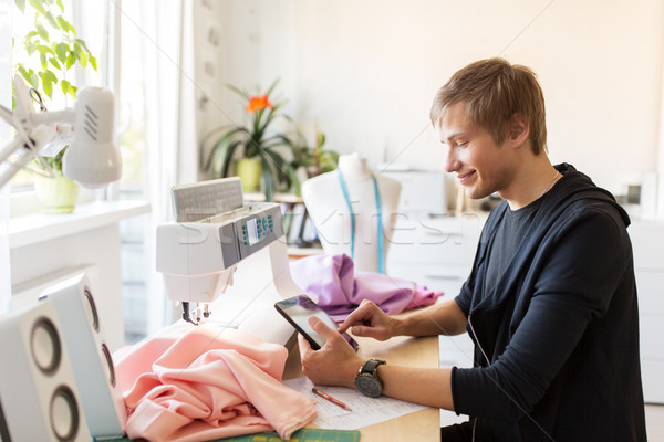 fashion designer with tablet pc working at studio Stock photo © dolgachov