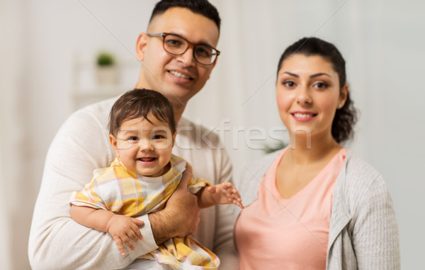 Stock photo: happy family with baby daughter at home
