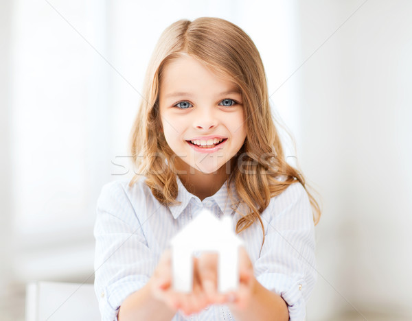 girl holding white paper house Stock photo © dolgachov