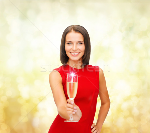 woman in red dress with a glass of champagne Stock photo © dolgachov