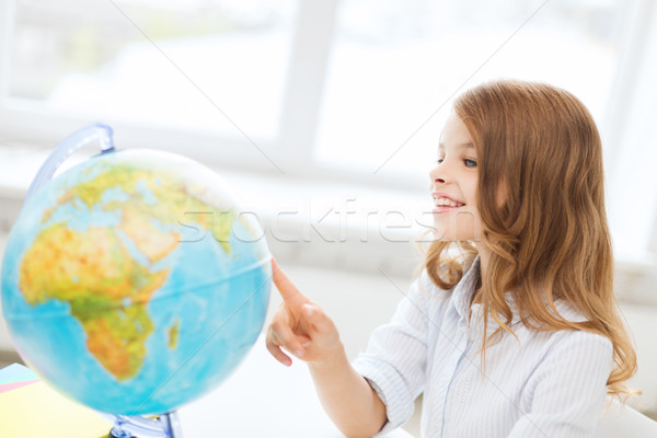 smiling student girl with globe at school Stock photo © dolgachov