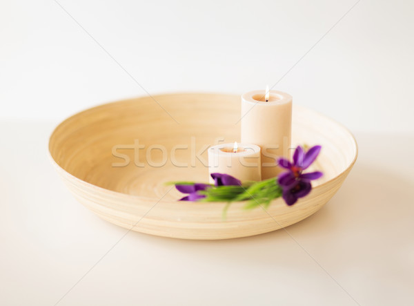 candles and iris flowers in wooden bowel Stock photo © dolgachov