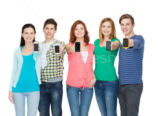 students showing blank smartphones screens Stock photo © dolgachov