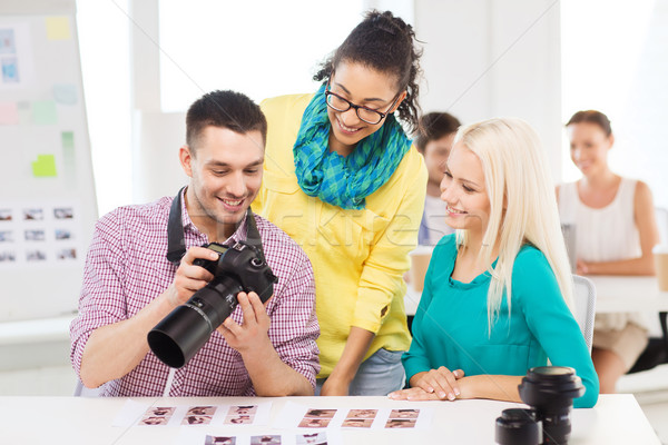 Stock photo: smiling team with photocamera working in office