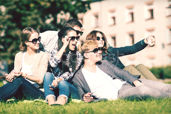 teenagers taking photo outside with smartphone Stock photo © dolgachov
