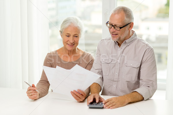 senior couple with papers and calculator at home Stock photo © dolgachov