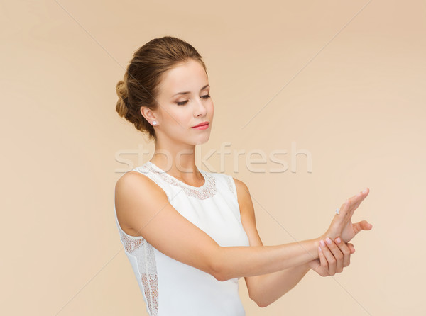 smiling woman in white dress with diamond ring Stock photo © dolgachov