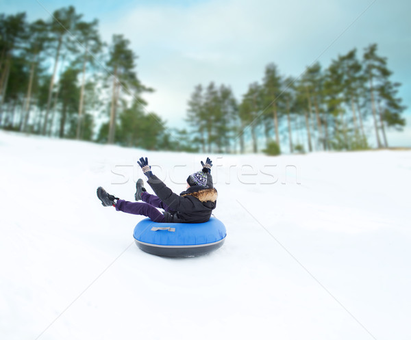 happy young man sliding down on snow tube Stock photo © dolgachov