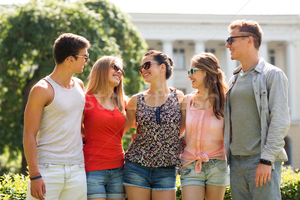 group of smiling friends outdoors Stock photo © dolgachov