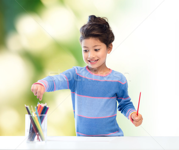 happy little girl drawing with coloring pencils Stock photo © dolgachov