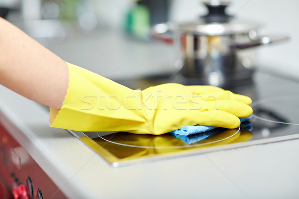 close up of woman cleaning cooker at home kitchen Stock photo © dolgachov