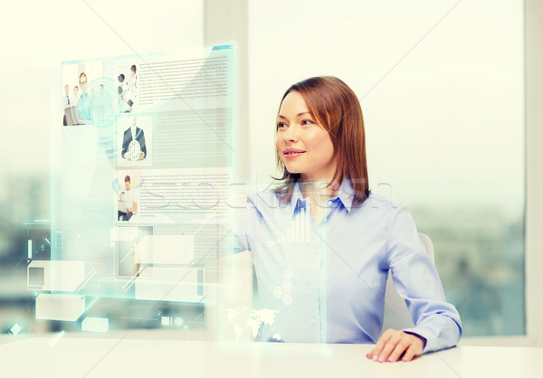 smiling woman pointing to news on virtual screen Stock photo © dolgachov