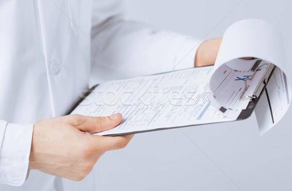 male doctor holding prescription paper in hand Stock photo © dolgachov