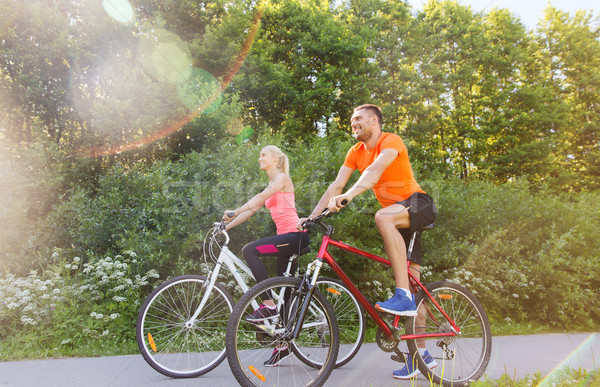 happy couple riding bicycle outdoors Stock photo © dolgachov