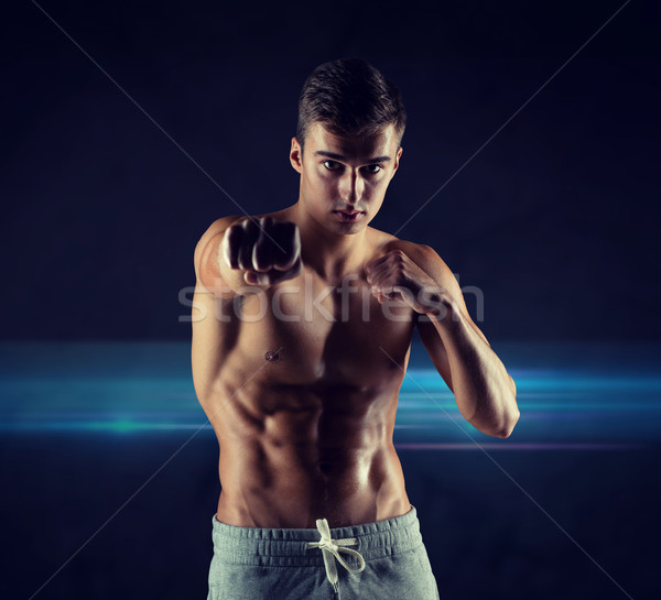 young man in fighting or boxing position Stock photo © dolgachov