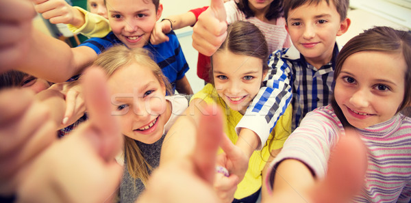 group of school kids showing thumbs up Stock photo © dolgachov