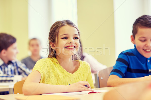 group of school kids writing test in classroom Stock photo © dolgachov