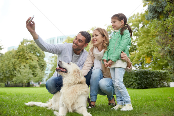 happy family with dog taking selfie by smartphone Stock photo © dolgachov