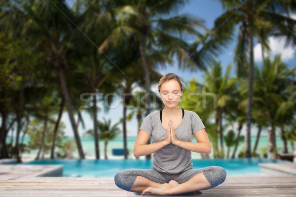 woman making yoga meditation in lotus pose Stock photo © dolgachov