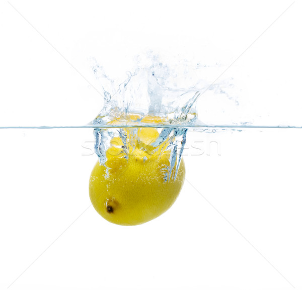 lemon falling or dipping in water with splash Stock photo © dolgachov