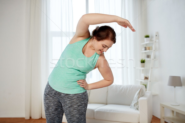 Plus size nő testmozgás nyújtás otthon fitnessz Stock fotó © dolgachov