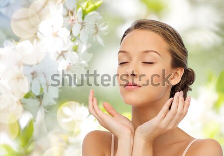 close up of beautiful woman face with gold earring Stock photo © dolgachov