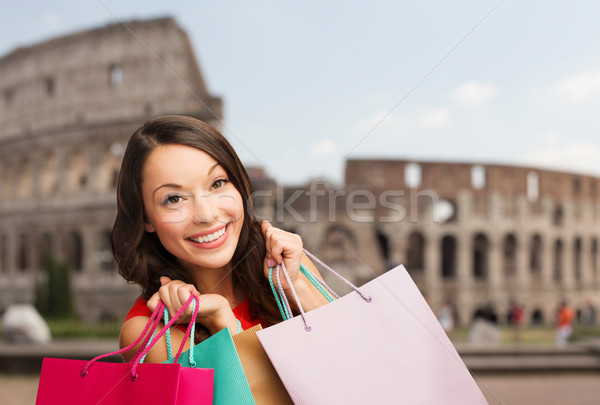 young happy woman with shopping bags over coliseum Stock photo © dolgachov