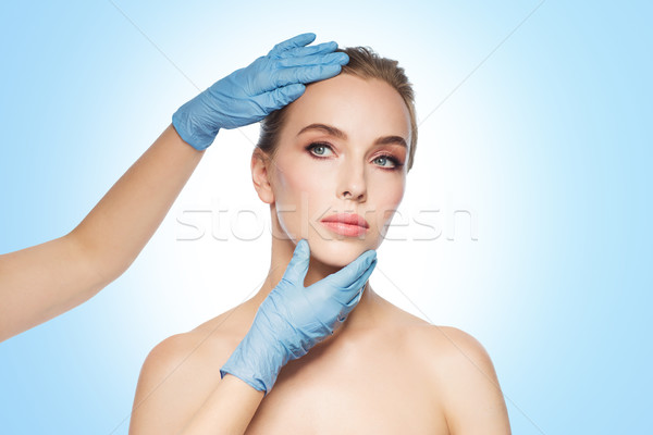 Stock photo: surgeon or beautician hands touching woman face