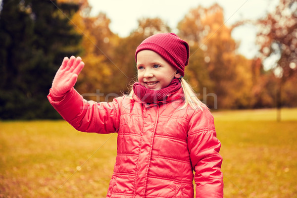happy little girl waving hand in autumn park Stock photo © dolgachov