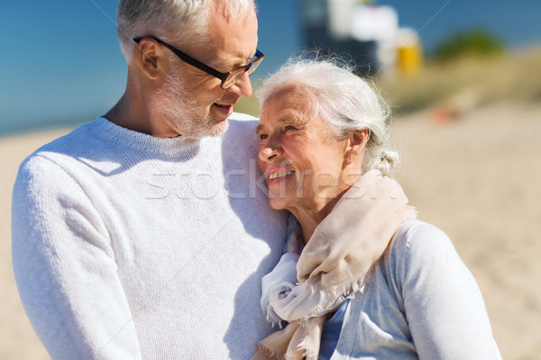 Stock photo: happy senior couple hugging on summer beach