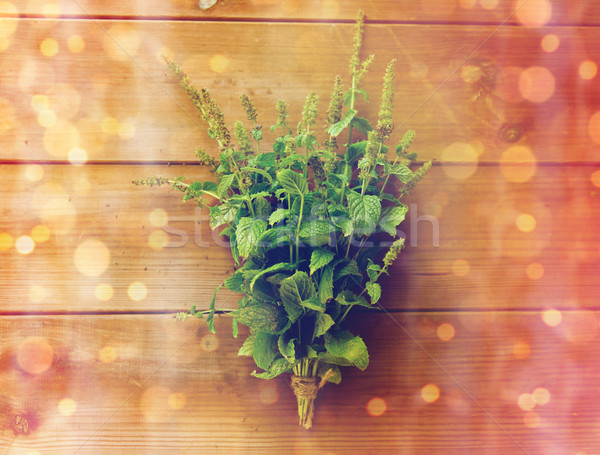 close up of fresh melissa bunch on wooden table Stock photo © dolgachov