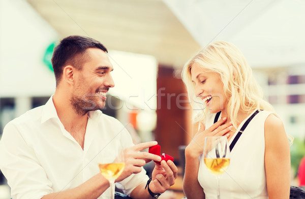 happy couple with engagement ring and wine at cafe Stock photo © dolgachov