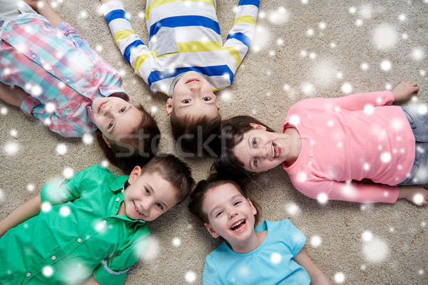 Feliz sonriendo ninos piso nieve Navidad Foto stock © dolgachov