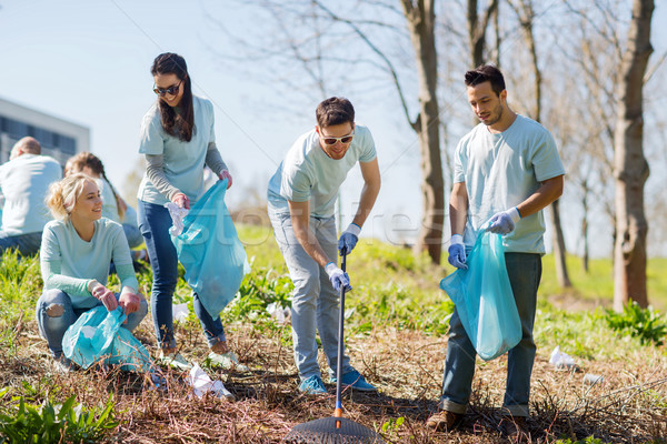 volunteers with garbage bags cleaning park area Stock photo © dolgachov