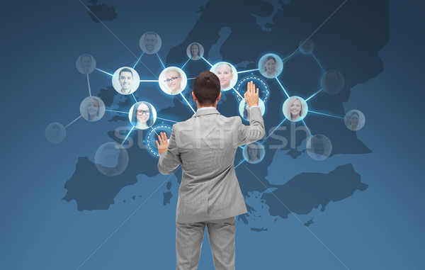 businessman using virtual screen with contacts Stock photo © dolgachov