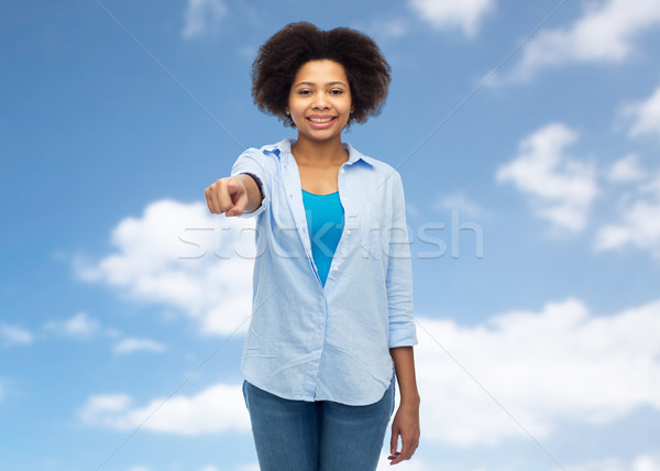 happy african woman pointing finger to you Stock photo © dolgachov