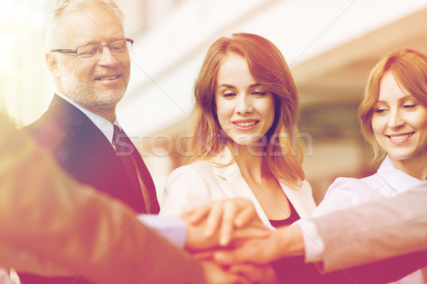 Stock photo: business people putting hands on top in office