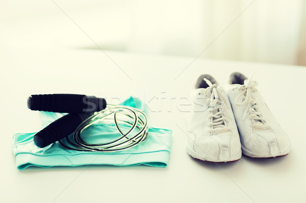close up of sports top, sneakers and skipping rope Stock photo © dolgachov