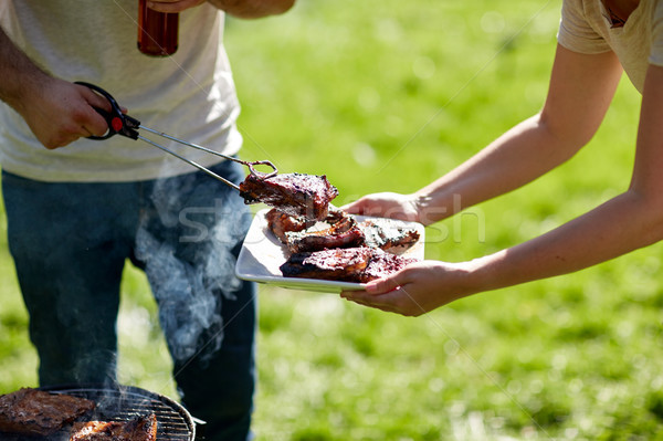 Stock photo: man cooking meat at summer party barbecue