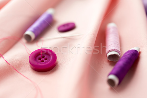sewing buttons, spools of thread and cloth Stock photo © dolgachov