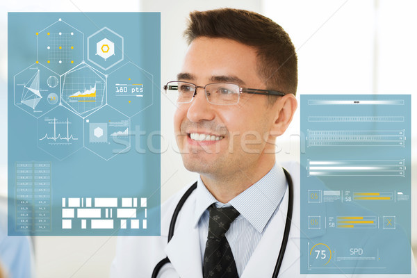 smiling male doctor in white coat and eyeglasses Stock photo © dolgachov