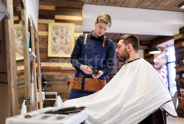 barber showing hair styling wax to male customer Stock photo © dolgachov