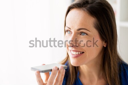 woman using voice recorder on smartphone Stock photo © dolgachov