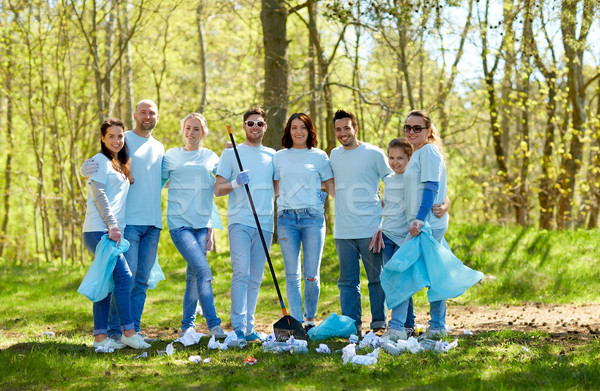 group of volunteers with garbage bags in park Stock photo © dolgachov