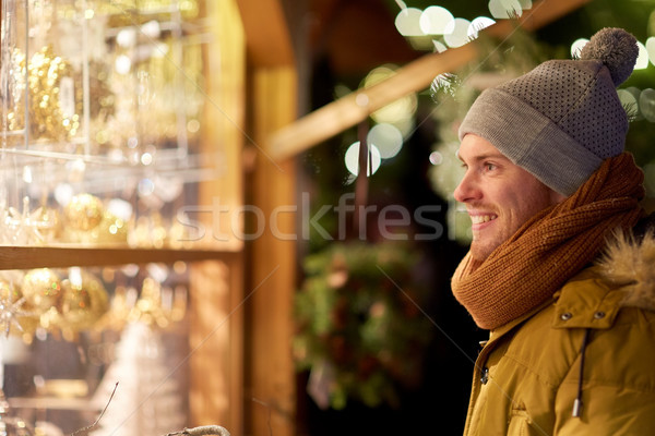 happy man looking at christmas market shop window Stock photo © dolgachov