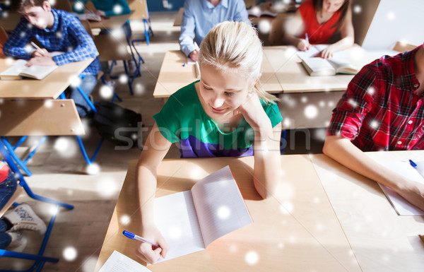 group of students with books writing school test Stock photo © dolgachov